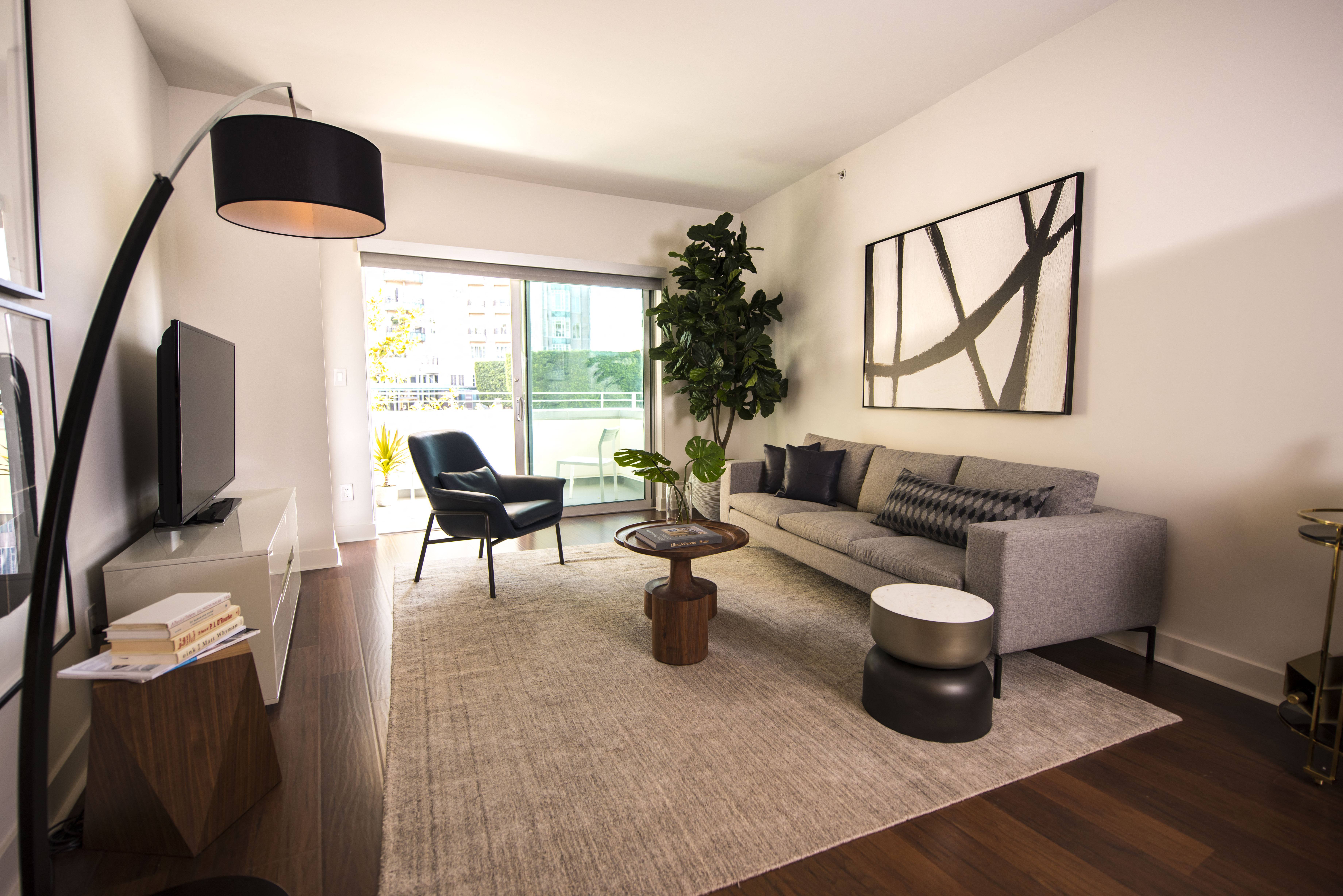 a living room with a gray couch and a coffee table
